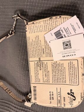 COACH Newspaper print Wristlet/Mini bag  new with tags